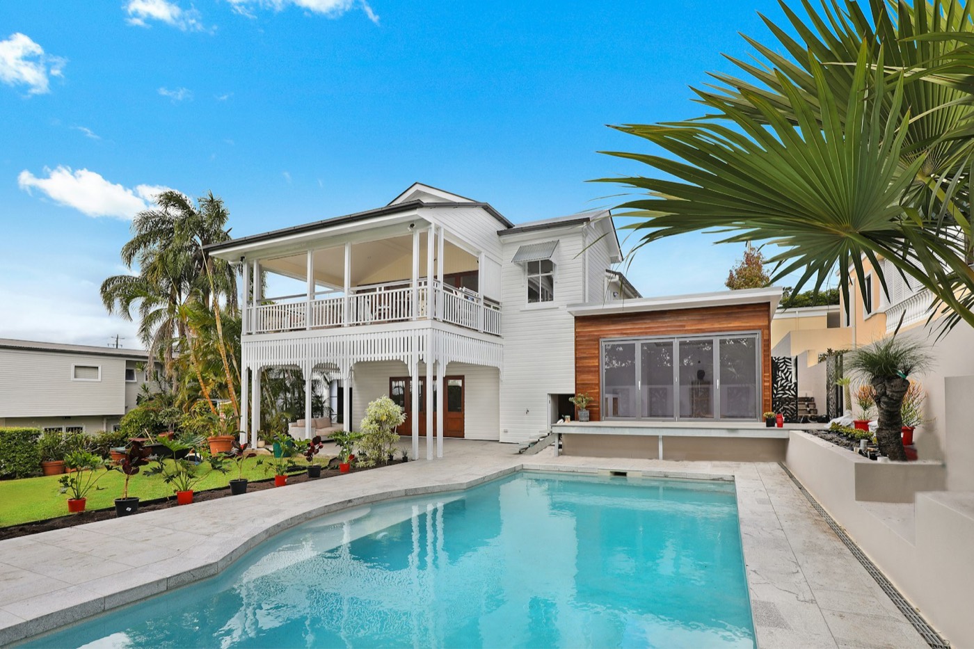 A large house with a swimming pool and landscaped garden